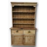Pine dresser of three shelves above base of two drawers and two doors, 133.5cm