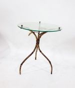 Gilt metal and glass tripod occasional table, circular with foliate decoration Damaged