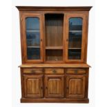 20th century dresser with moulded pediment above central open recess with adjustable shelves,