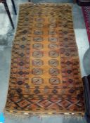 Mustard yellow ground Eastern rug, the mustard central field decorated with two rows of nine