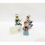 Three Lladro figures of harlequin boys, each sitting on integral pedestal bases, lettered A, B and C