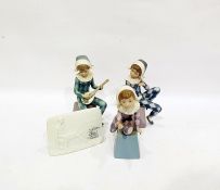 Three Lladro figures of harlequin boys, each sitting on integral pedestal bases, lettered A, B and C