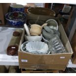 Box of various glass and ceramic jelly moulds and a wooden pestle and mortar
