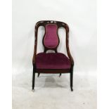 Victorian mahogany-framed low salon chair in plum upholstered back and seat, saber front legs