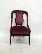 Victorian mahogany-framed low salon chair in plum upholstered back and seat, saber front legs