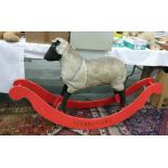 'Rambustious' hide rocking sheep (fur worn) on a red painted rocker