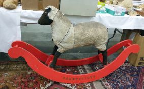 'Rambustious' hide rocking sheep (fur worn) on a red painted rocker