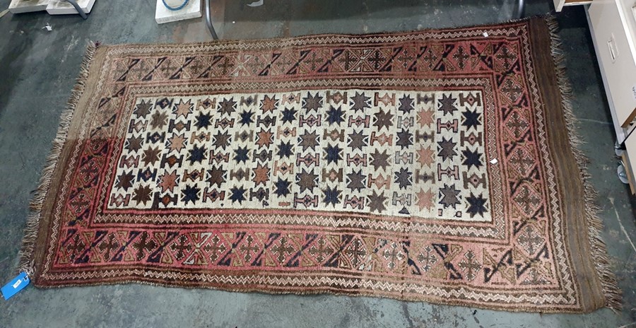 Eastern rug, the cream ground central field with repeating star motif to the centre, on a salmon