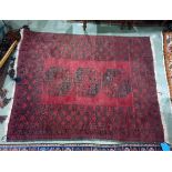 Red ground Eastern style floor rug with three central medallions, 152cm x 116cm