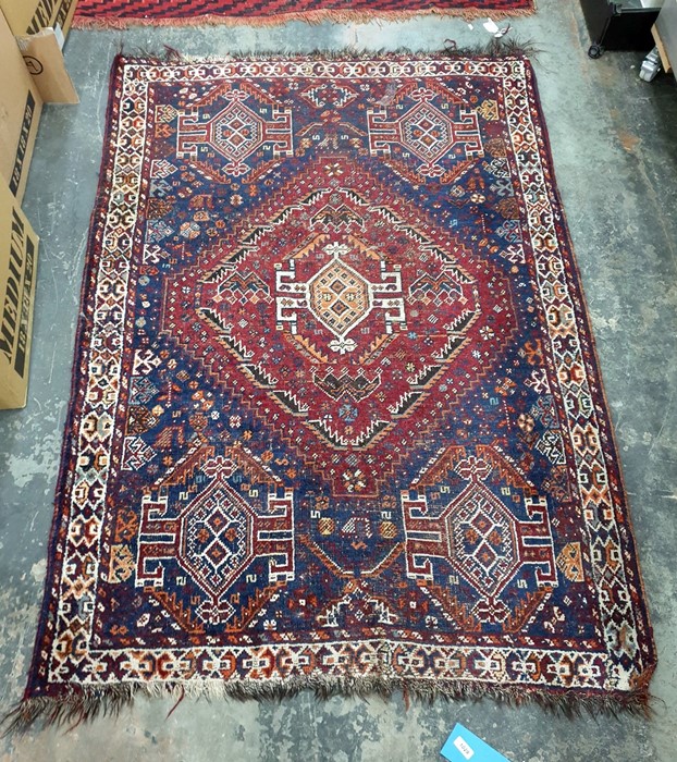 Eastern blue ground rug, the red ground central medallion decorated in oranges, creams, blues and