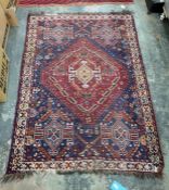 Eastern blue ground rug, the red ground central medallion decorated in oranges, creams, blues and