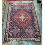 Eastern blue ground rug, the red ground central medallion decorated in oranges, creams, blues and