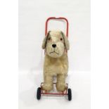 Push-along plush dog on wheels with red handle
