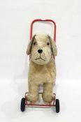 Push-along plush dog on wheels with red handle