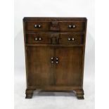 20th century oak tallboy with two drawers above two cupboard doors, to ogee bracket feet