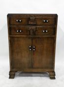 20th century oak tallboy with two drawers above two cupboard doors, to ogee bracket feet