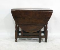 Antique oak small gateleg dining table with oval top and baluster turned uprights, 128cm wide