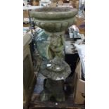 Stone birdbath, cherub supporting bowl, and a stone Chinese style pagoda garden ornament