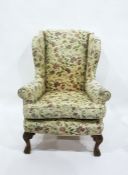 Wing armchair in floral weave, on ornate carved cabriole supports