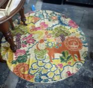 Kashmiri wool hand-stitched circular rug on a cream ground, decorated with lion and birds amongst