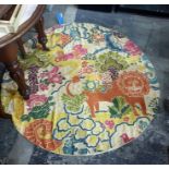 Kashmiri wool hand-stitched circular rug on a cream ground, decorated with lion and birds amongst