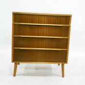 Mid 20th century teak chest of four long drawers, on turned supports, 76.5cm