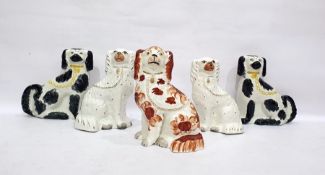 Two pairs of Staffordshire spaniel ornaments, one white pair with gilt hightlights, the other