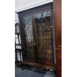 20th century Chippendale-style mahogany glazed bookcase, the top with blind fret carved frieze above