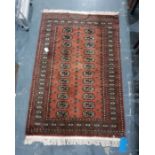 Brown ground Eastern floor rug with two rows of 12 elephant foot guls to the central field and