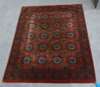 Eastern rug, the dark orange central field decorated with five rows of four elephant foot guls,