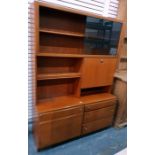 Mid 20th century teak lounge unit with sliding glass doors enclosing two shelves, above assorted