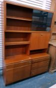 Mid 20th century teak lounge unit with sliding glass doors enclosing two shelves, above assorted