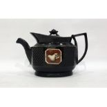 Early 19th century pottery teapot of shaped black glazed oval form, set with agate-effect shell