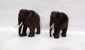 Pair of carved hardwood elephants with bone tusks (2)