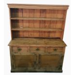 19th century pine dresser with moulded pediment above two shelves, resting upon a base of three