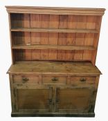19th century pine dresser with moulded pediment above two shelves, resting upon a base of three