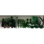 Large quantity of green glass tableware including a large bowl on pedestal foot, a set of 10 wine