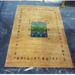 Yellow ground floor rug with central variegated green/blue ground panel decorated with antelope, the