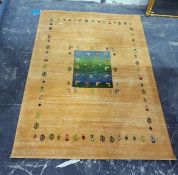 Yellow ground floor rug with central variegated green/blue ground panel decorated with antelope, the