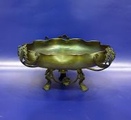 Art Nouveau iridescent green glass bowl of folded circular form, set within a pierced metal pedestal