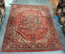 Eastern brown ground floor rug with central cream ground and orange medallion to stepped border,