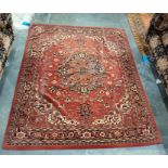 Eastern brown ground floor rug with central cream ground and orange medallion to stepped border,