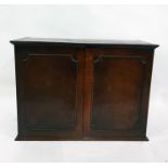 Mahogany cupboard with shelves enclosed by pair frame panelled doors