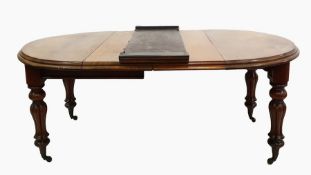 William IV extending dining table of elongated oval form, the moulded edge above the turned reeded