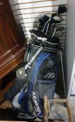 Maxwell, Slingshot and other golf clubs in a Mizumo carry bag together with a green trunk and