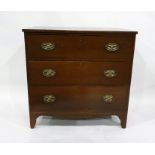 Antique mahogany chest of three long drawers with brass drop handles and oval backplates, on bracket