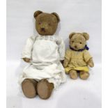 Large teddy bear with glass eyes and stitched nose, straw stuffed, in a white nightgown height 57cm,
