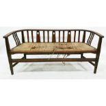 Probably an E. A. Taylor for Wylie and Lochhead, an Arts & Crafts oak settee, the curved back rail