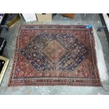 Antique Persian style wool rug with central red lozenge shaped medallion on a midnight blue field
