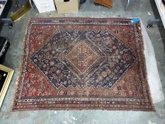 Antique Persian style wool rug with central red lozenge shaped medallion on a midnight blue field